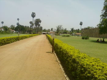 Empty road passing through field