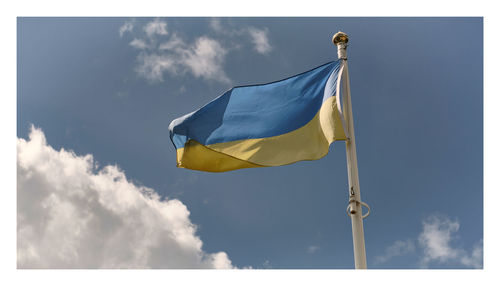 Low angle view of flag against sky