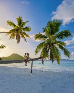 People on beach against sky