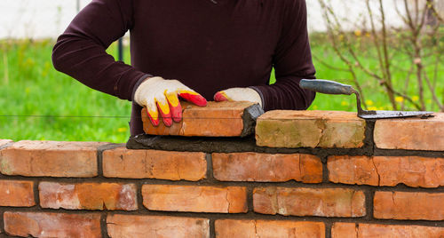 Man working on brick wall