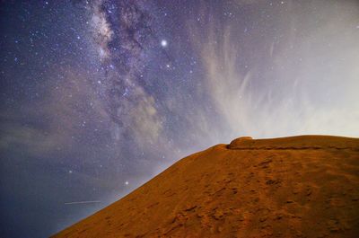 Scenic view of mountain against sky at night