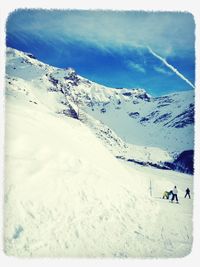 Tourists on snow covered landscape