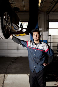 Portrait of man standing in auto repair shop