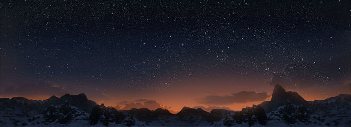 Scenic view of snowcapped mountains against sky at night