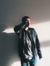 Young woman standing against white background