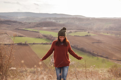 Full length of woman standing on field