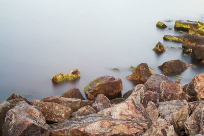 Rocks on beach against sky