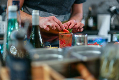 Midsection of man preparing food in kitchen