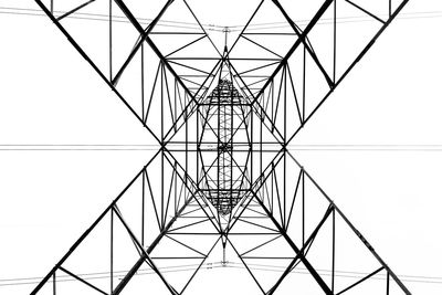 From below black and white close up of energy tower creating abstract background geometric shapes