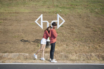 Rear view of couple standing on road