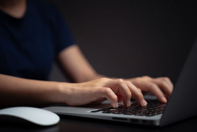 Midsection of man using mobile phone on table