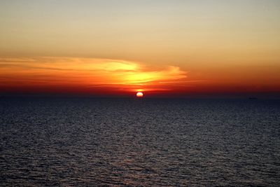 Scenic view of sea against romantic sky at sunset