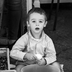 Portrait of boy sitting outdoors