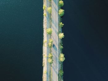 Aerial view of car on bridge by sea
