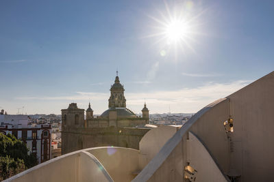 Historic church in city against blue sky