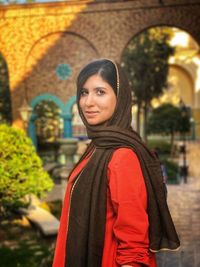 Portrait of smiling young woman standing outdoors