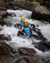 Man and woman surfing in river . river tubbing