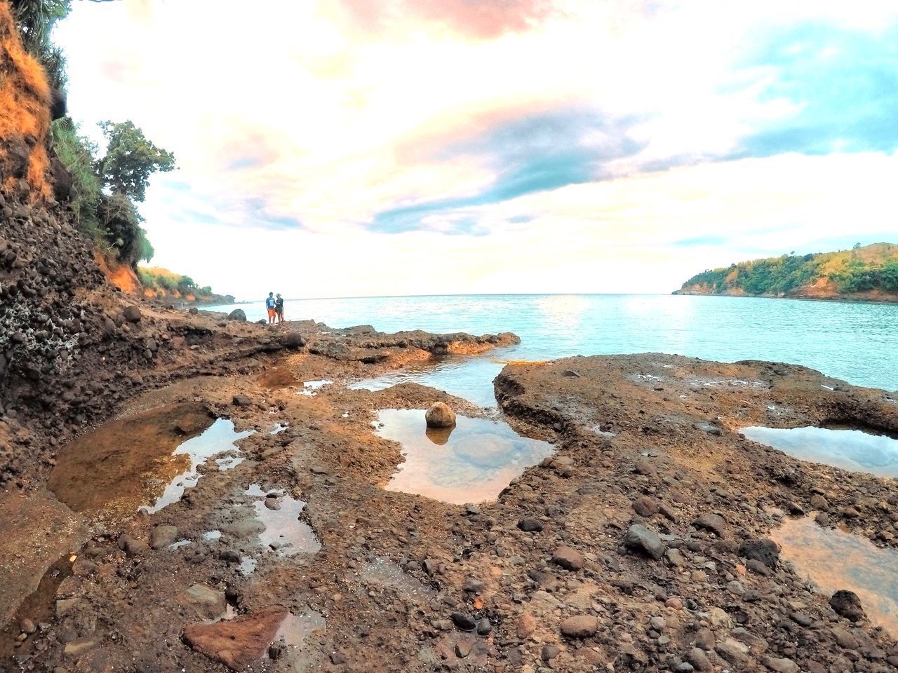 ROCKS ON BEACH AGAINST SKY