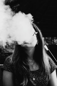 Portrait of young woman smoking