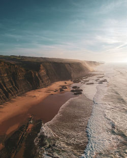 Aerial view of waves on a beautiful sandy ocean beach and cliff. panorama atlantic coastline.