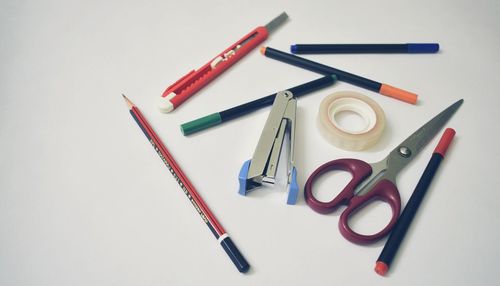 High angle view of colored pencils on white background