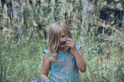 Full length of girl holding plant