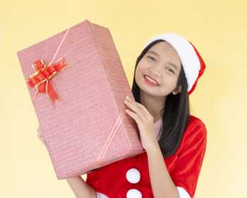 Portrait of a smiling young woman against white background