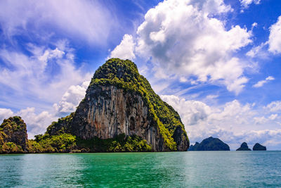 Scenic view of rock formation in sea against sky