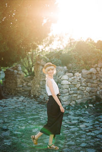 Full length of young woman standing in lake