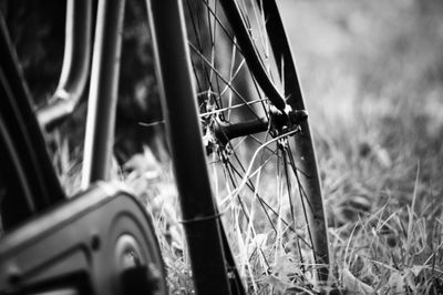 Close-up of bicycle wheel on field