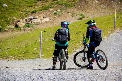 Rear view of man riding bicycle