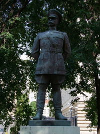 Low angle view of statue against trees