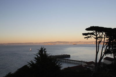 Scenic view of sea against clear sky at sunset
