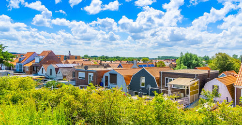 Panoramic view of houses and buildings against sky