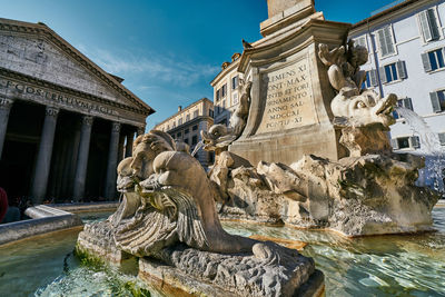 Statue of fountain in front of building