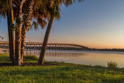 Scenic view of river against sky at sunset