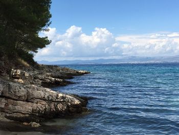 Scenic view of sea against cloudy sky