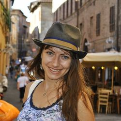 Close-up portrait of young woman standing on street in city