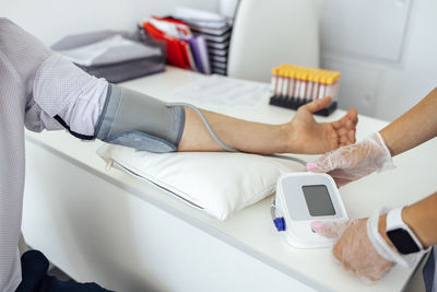 Midsection of doctor examining patient in hospital