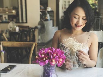 Beautiful woman sitting on table