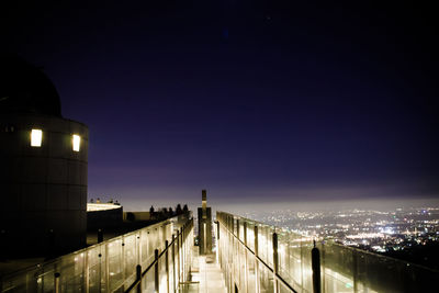 Illuminated buildings against sky at night