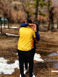 Rear view of man photographing