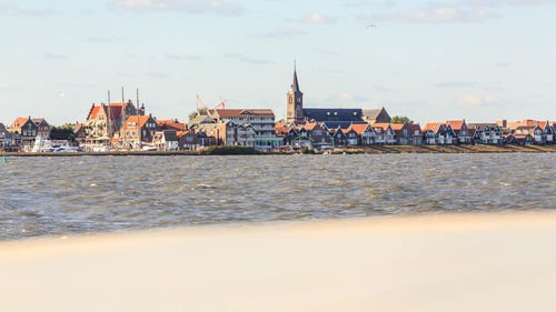 Sea with buildings in background