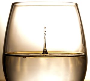 Close-up of glass of water against white background