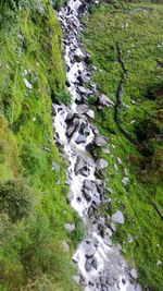 High angle view of waterfall amidst rocks