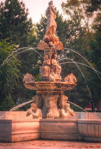 Low angle view of statue against trees in park