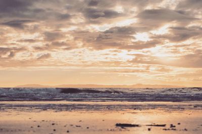 Scenic view of beach against sky during sunset