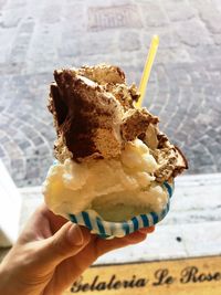 Close-up of hand holding ice cream cone