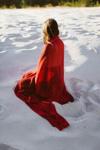 Rear view of woman with umbrella on beach