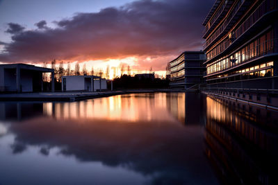 Scenic shot of river with buildings in background